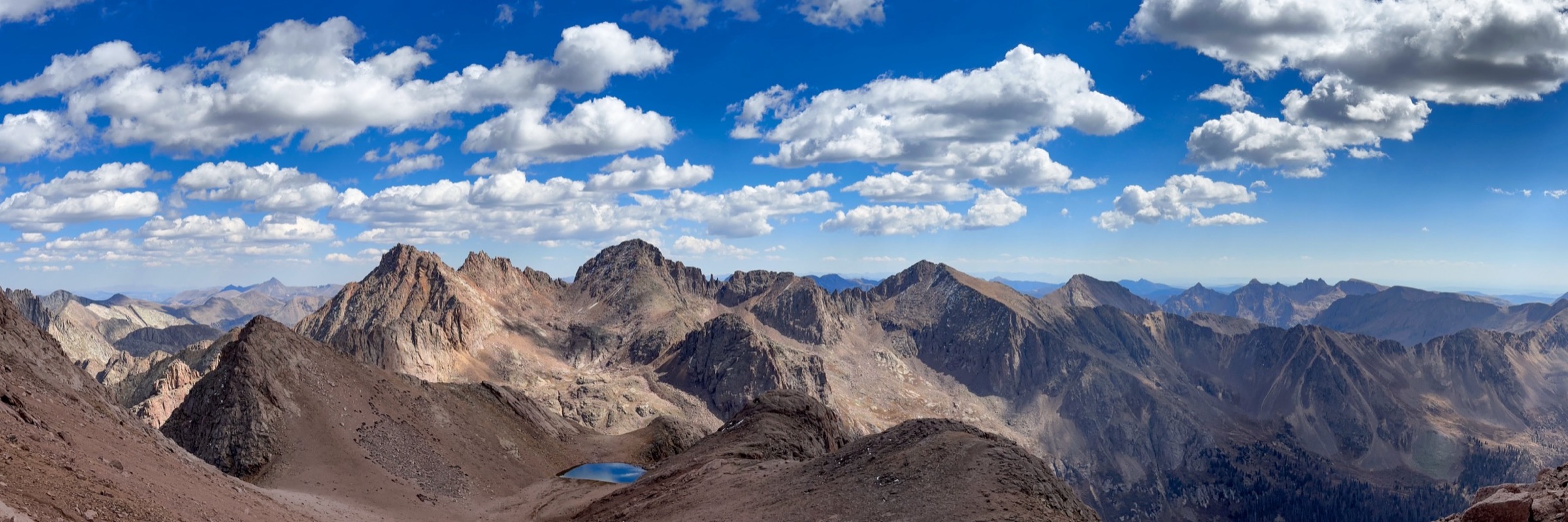 High terrain under a wide, moving sky